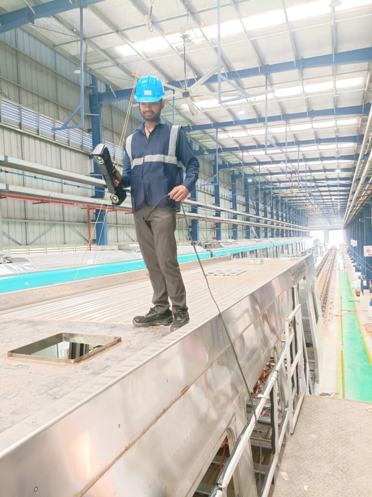 Engineer performing large-part 3D laser scanning on a metro wagon frame using Creaform HandySCAN 3D MAX